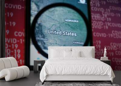 United states country on google maps under magnifying glass with Red Covid-19 text Background. Selective Focus. Wall mural