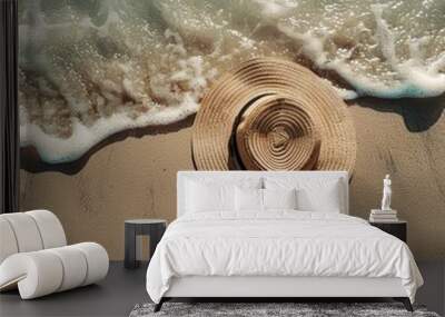 Straw hat and sunglasses on sandy beach by ocean. Summer vacation, travel, beachwear, leisure, relaxation, tropical holiday, sunny destination. Wall mural