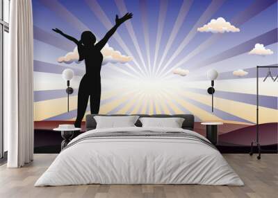 Successful woman standing on filed with arms open  and sunshine background. Wall mural