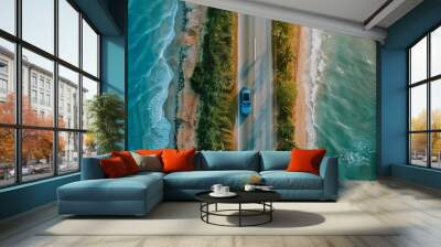 A car drives on a highway next to the ocean. This could represent vacation or renting a car. Wall mural