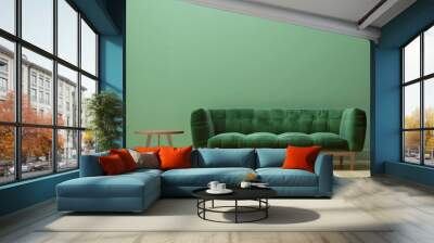 a comfortable green sofa faces a green wall with a small table. the floor is made of light-colored w Wall mural