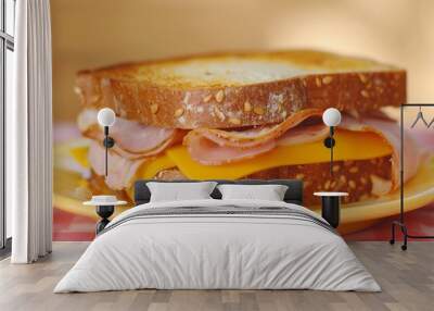 A tasty ham and cheese sandwich on a yellow plate. Wall mural