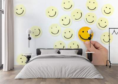 Yellow happy face icons group set top view with human hand. Share happiness positivity and joy concept. Wall mural