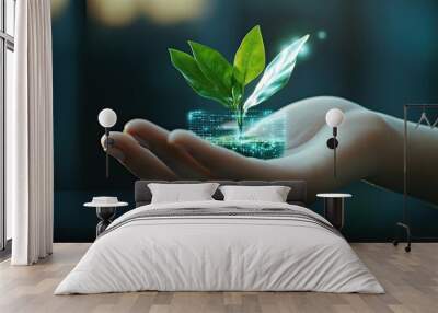 A hand gently holds a small plant, symbolizing growth and sustainability in a digital world. Wall mural