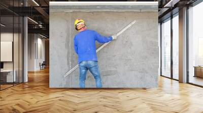 Plasterers using trowels mason for plastering and leveling mortar concrete on the brick wall at the construction under building Wall mural