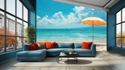 A vibrant beach umbrella provides shade on the sandy shore overlooking the sparkling ocean, with people enjoying the coastal natural landscape under a clear sky AIG50 Wall mural