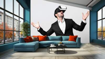 Business man looking data analysis by using VR glasses. Project manager checking business strategy by enter in metaverse or virtual reality world while wearing suit at white background. Deviation. Wall mural