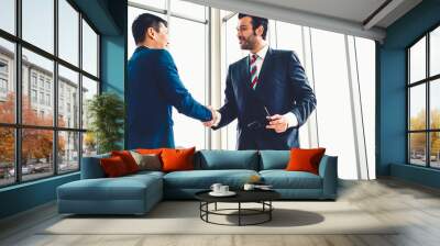 Business people handshake in corporate office showing professional agreement on a financial deal contract. Wall mural