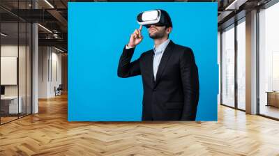 Caucasian business man planning financial plan while using VR goggle. Professional project manager standing and touching VR headset while using visual reality glasses to connect metaverse. Deviation. Wall mural