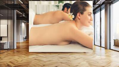 Caucasian couple customer enjoying relaxing anti-stress spa massage and pampering with beauty skin recreation leisure in day light ambient salon spa at luxury resort or hotel. Quiescent Wall mural