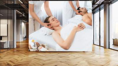 Caucasian couple enjoying relaxing anti-stress head massage and pampering facial beauty skin recreation leisure in dayspa modern light ambient at luxury resort or hotel spa salon. Quiescent Wall mural