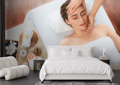 Caucasian woman enjoying relaxing anti-stress head massage and pampering facial beauty skin recreation leisure in dayspa modern light ambient at luxury resort or hotel spa salon. Quiescent Wall mural