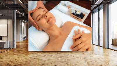 Caucasian woman enjoying relaxing anti-stress head massage and pampering facial beauty skin recreation leisure in dayspa modern light ambient at luxury resort or hotel spa salon. Quiescent Wall mural