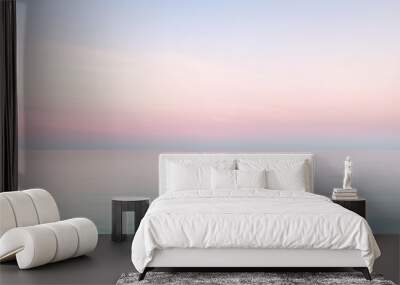 Clear blue sky sunset with glowing pink and purple horizon on calm ocean seascape background. Picturesque generative ai Wall mural