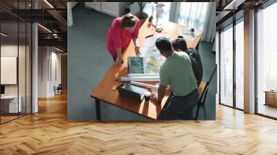 Close up of civil engineer hands holding and asking project manager about plan. Group of architect brainstorming and explaining blueprint while sitting at meeting table with project plan. Symposium. Wall mural