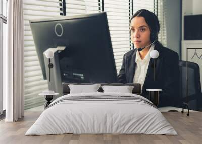 Competent female operator working on computer and talking with clients. Concept relevant to both call centers and customer service offices. Wall mural