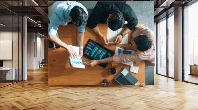 Executive manager explain financial graph to colleague at meeting room. Top aerial view of diverse marketing team sharing idea and planning strategy while sitting at table with tablet. Convocation. Wall mural