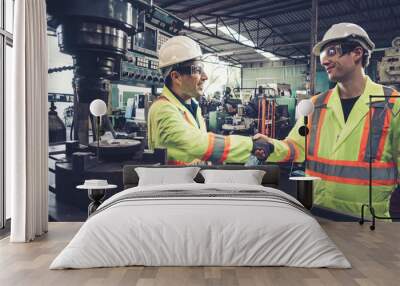 Factory workers handshake with team member in the factory . Industry people teamwork and trust concept . Wall mural