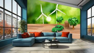 Green eco car and windmill turbine model with park on office table design. Sustainable and renewable clean solution with zero CO2 emission for green ecology and environmental concept. Alter Wall mural