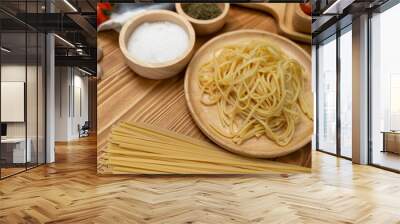 Health food's recipe ingredients of special menu homemade cooking raw spaghetti with tomato sauce and basil of macro photo shooting placing elements on preparing wooden blurred background. Postulate. Wall mural