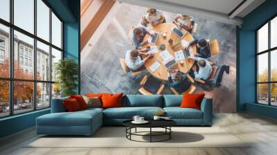 High-angle shot of professionals having a corporate meeting around a circular table in a modern office. AIG53M Wall mural