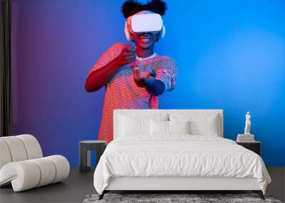 Hunting African gamer wearing VR turning metaverse world playing gun shooting hunter isolate blue neon light connect victory animal hunting futuristic technology hologram virtual reality. Contrivance. Wall mural