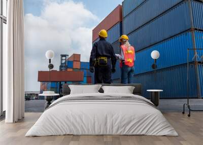 industrial worker works with co-worker at overseas shipping container yard . logistics supply chain  Wall mural