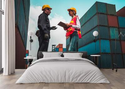 industrial worker works with co-worker at overseas shipping container yard . logistics supply chain  Wall mural