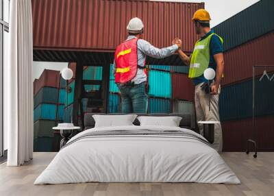 Industrial worker works with co-worker at overseas shipping container yard . Logistics supply chain management and international goods export concept . Wall mural