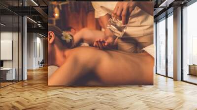 Masseur hands pouring aroma oil on couple customer back. Masseuse prepare oil massage procedure for customer at spa salon in luxury resort. Aroma oil body massage therapy concept. Quiescent Wall mural