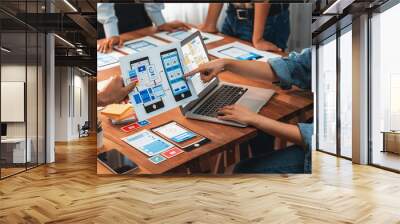 Panorama shot of front-end developer team brainstorming UI and UX designs for mobile app on paper wireframe interface. User interface development team planning for user-friendly UI design. Scrutinize Wall mural