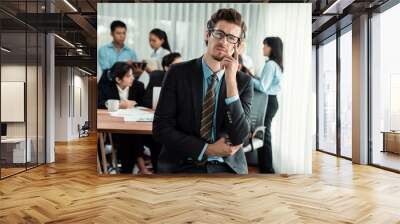 Portrait of happy businessman looking at camera with motion blur background of business people movement in dynamic business meeting. Habiliment Wall mural