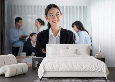 Portrait of happy young asian businesswoman looking at camera with motion blur background of business people movement in dynamic business meeting. Habiliment Wall mural