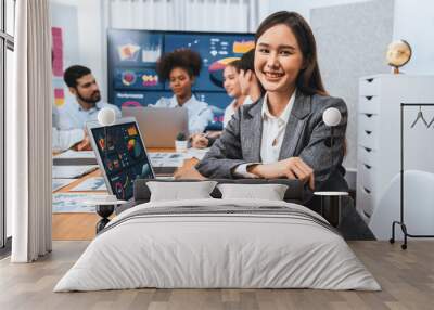 Portrait of happy young asian businesswoman with group of office worker on meeting with screen display business dashboard in background. Confident office lady at team meeting. Concord Wall mural