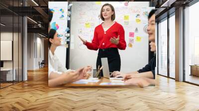 Professional attractive female leader presents creative marketing plan by using brainstorming mind mapping statistic graph and colorful sticky note at modern business meeting room. Immaculate. Wall mural