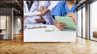 Professional various team of medical working and planning medical treatment at hospital table together. Teamwork lead to successful illness and sickness treatment. Panorama Rigid Wall mural