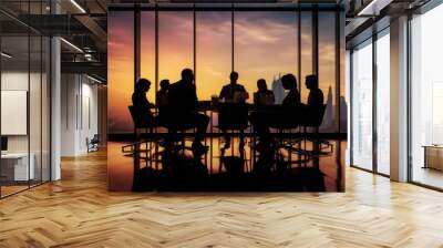 Silhouettes of group of business people against sunset comeliness Wall mural