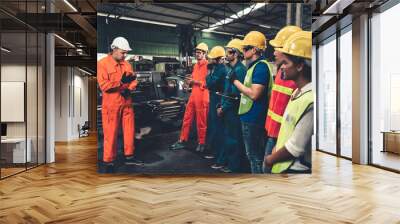 Skillful worker attending brief meeting in the factory . Industrial people and manufacturing labor concept . Wall mural