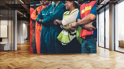 Skillful worker stand together showing teamwork in the factory . Industrial people and manufacturing labor concept . Wall mural