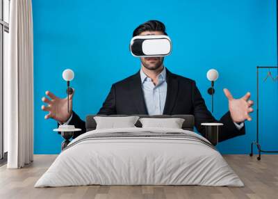 Smart business man with suit holding something while VR goggle to connect metaverse. Professional project manager looking at hologram by using visual reality headset. Technology innovation. Deviation. Wall mural