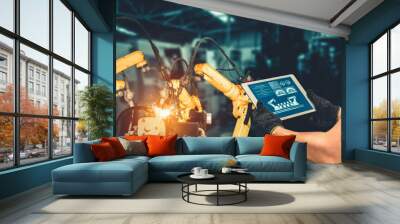 Smart industry robot arms for digital factory production technology showing automation manufacturing process of the Industry 4.0 or 4th industrial revolution and IOT software to control operation . Wall mural