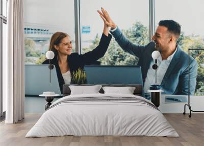 Success business partner - Businesswoman and businessman celebrating together in modern workplace office. People corporate teamwork concept. uds Wall mural