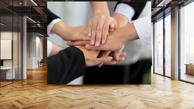 Top view closeup business team of suit-clad businesspeople join hand stack together. Colleague collaborate and work together to promote harmony and teamwork concept in office workplace. Wall mural