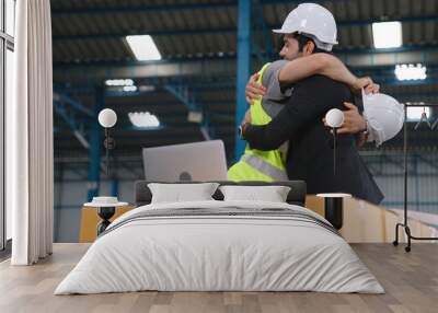 Two factory worker celebrate success together in the factory or warehouse . Industry work achievement concept . Wall mural