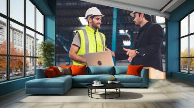 Two factory workers working and discussing manufacturing plan in the factory . Industry and engineering concept . Wall mural