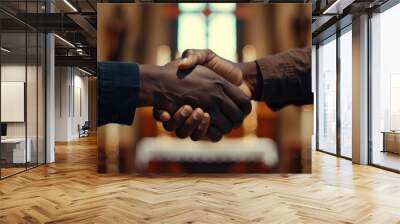 Two people of different races shaking hands in a church. Wall mural