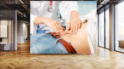 Woman Doctor and Male Patient in Hospital Office Wall mural