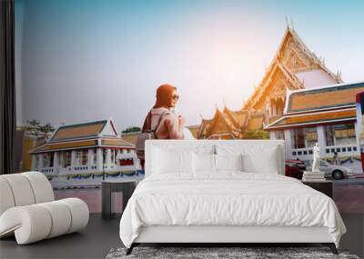 Back view of muslim Woman tourist walking in the buddha temple, Bangkok, popular famous location of city travel destination. Travel concept. Wall mural