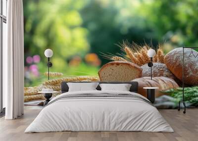 A beautifully arranged assortment of carbohydrate-rich foods, including bread, pasta, and grains, displayed on a rustic wooden table in a serene garden. Wall mural