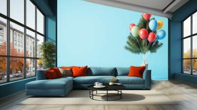 Christmas tree lifted up by colorful balloons against sky blue background. New Year concept. Wall mural